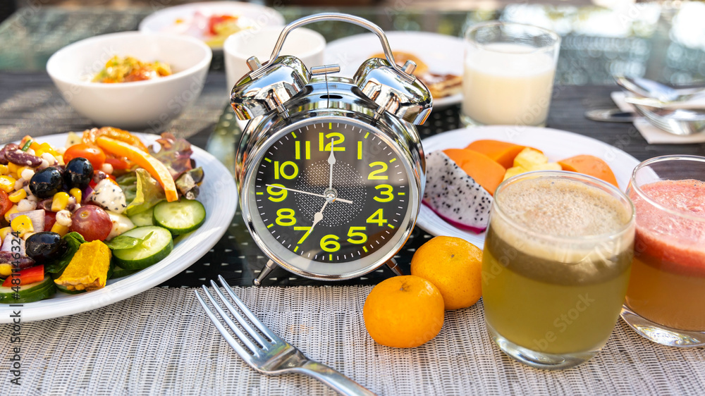 Selective focus of alarm clock which the  concept of proper nutrition. Diet intermittent fasting image